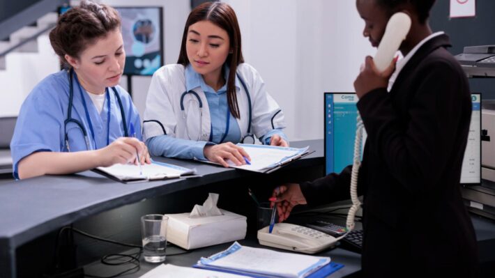 Healthcare operations female staff managing appointments in a healthcare center