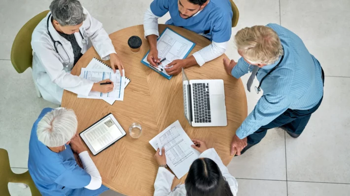 Team of healthcare physicians during an RCM meeting