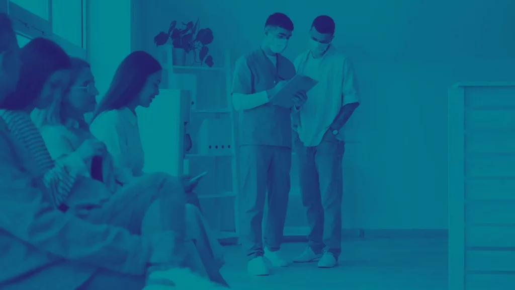 Healthcare center wait room filled with patients and doctors