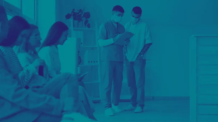 Healthcare center wait room filled with patients and doctors