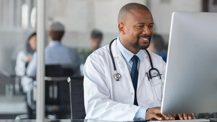 doctor on computer testing patient scheduling solution